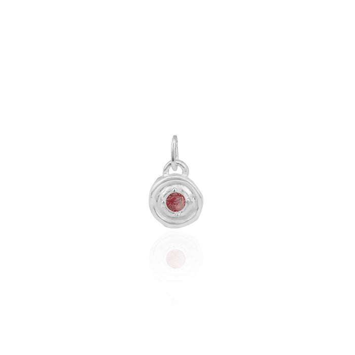 Silver pendant with a red gemstone on a white background