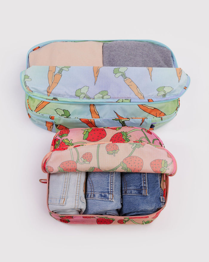 Large packing cube set with pastel animal print and folded denim inside, zipped