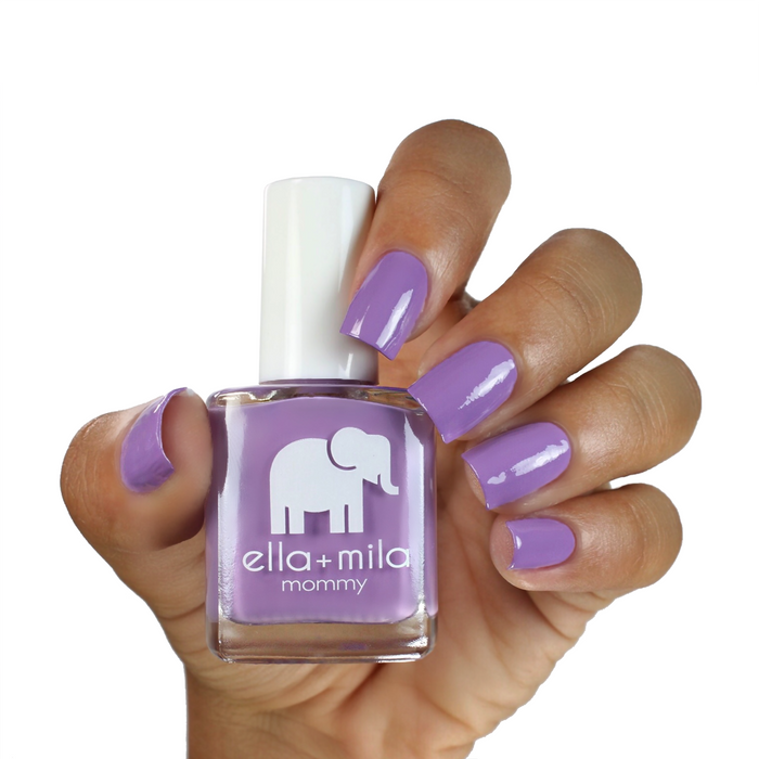 Lavender Fields pastel purple nail polish on a medium skin tone, hand holding the bottle