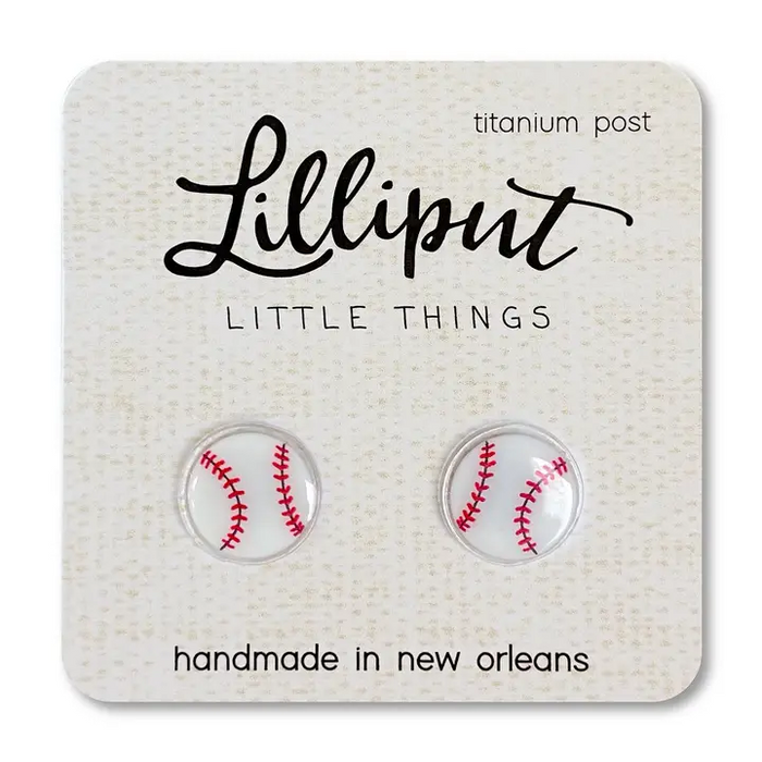 Lilliput Little Things Earrings: Handmade, hypoallergenic round baseball earrings with red stitching and titanium posts. Crafted in New Orleans and displayed on a branded card.