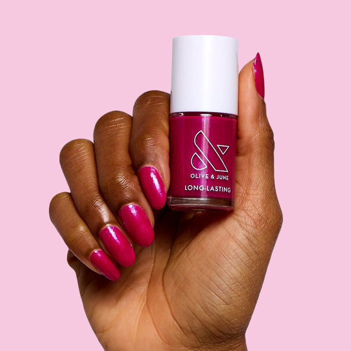Lily Blooms deep magenta polish on natural nails with a shiny finish for a long-lasting at-home manicure