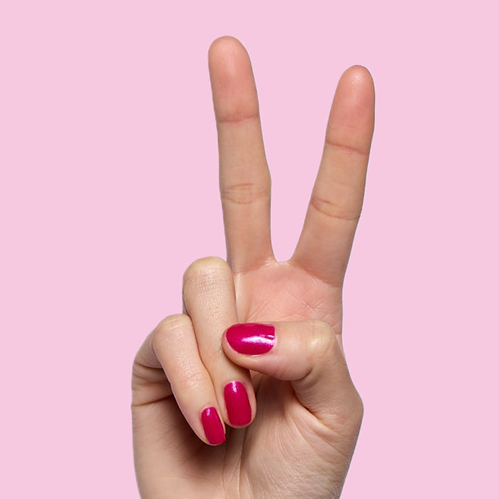 Lily Blooms shimmering magenta nail polish on natural nails with a glossy finish for a long-lasting at-home mani