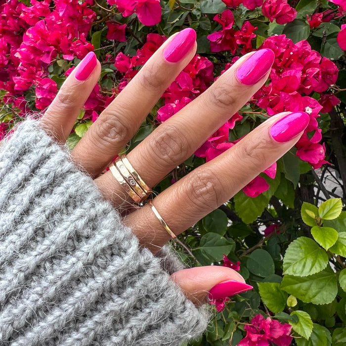 Lily Blooms bright magenta gel polish on natural nails with a shiny finish for a vibrant at-home manicure