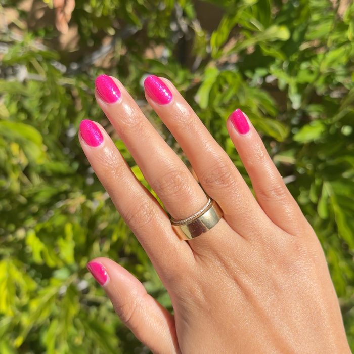 Lily Blooms vibrant magenta gel polish on natural nails with a shimmering, glossy finish for a quick dry at-home manicure
