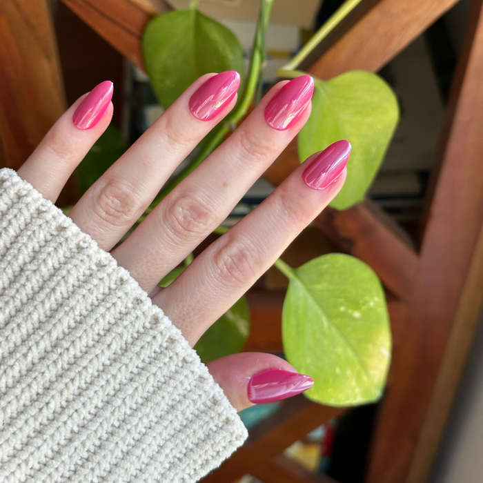Magenta Chrome - Press-On | Medium | Almond showing hand with medium almond shaped deep magenta shiny chrome press-on nails