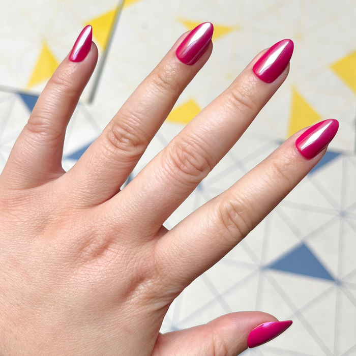 Magenta Chrome - Press-On | Medium | Almond showing hand with medium almond-shaped deep magenta shiny chrome press-on manicure