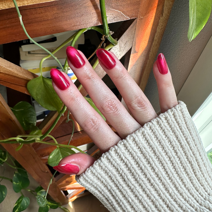 Magenta Velvet - Press-On | Medium | Oval showing hand with medium oval magenta velvet press-on nails in natural indoor light