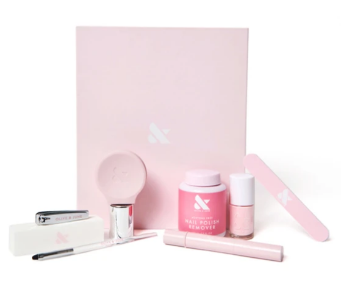 Mani Box Studio with pink nail polish remover, nail file, brush, clipper, and manicure tools for at-home nail care