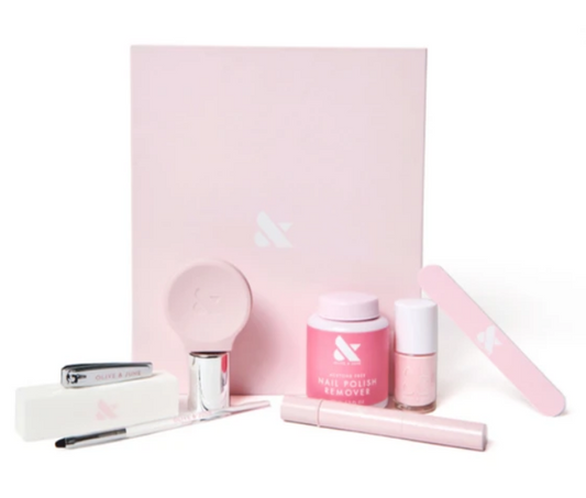 Mani Box Studio with pink nail polish remover, nail file, brush, clipper, and manicure tools for at-home nail care