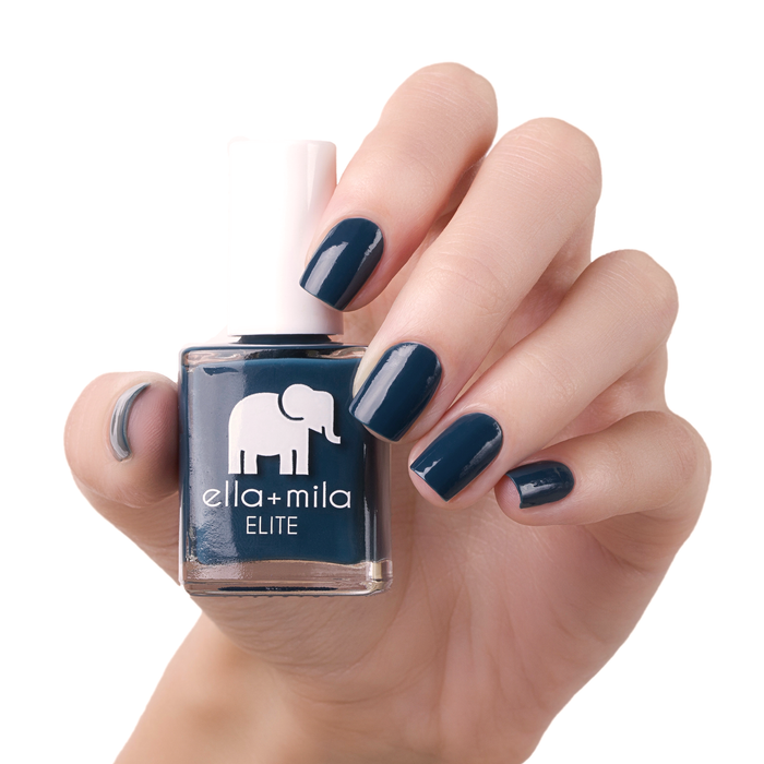 Mediterranean Mist dark blue green nail polish manicure on a light skin tone with the bottle