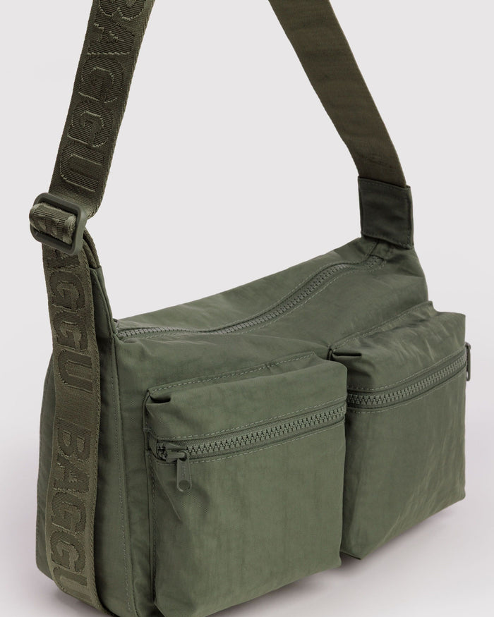 Olive green medium cargo crossbody bag side view with front zip pocket and strap.