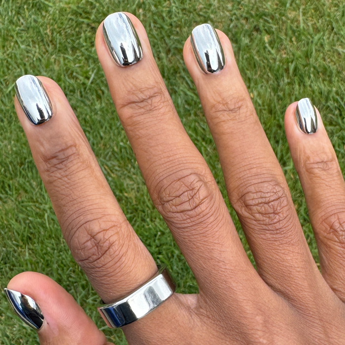 Mirror Chrome - Press-On | Extra Short | Round showing hand with extra short round mirror chrome press-on nails in reflective silver finish