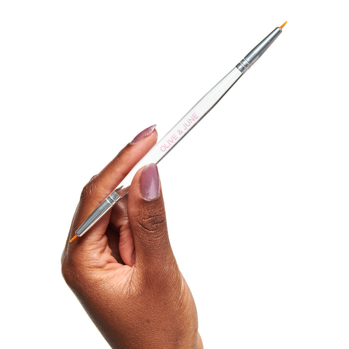 Hand holding the Nail Art Brush Set with fine brush tip for detailed at-home mani and nail polish designs