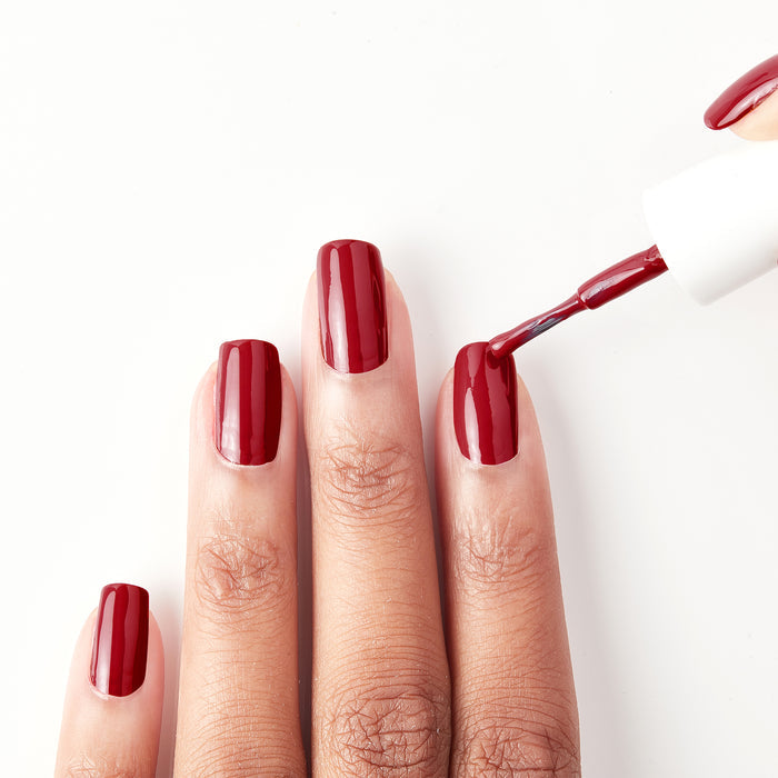 Applying Naughty Not Nice ruby red nail polish
