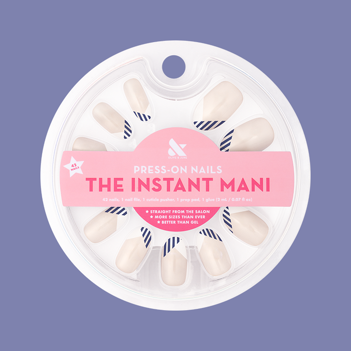 Nautical Split French - Press-On | Medium | Oval with navy striped french manicure shown in round packaging on purple background