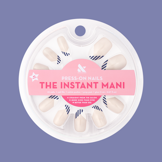 Nautical Split French - Press-On | Medium | Oval with navy striped french manicure shown in round packaging on purple background