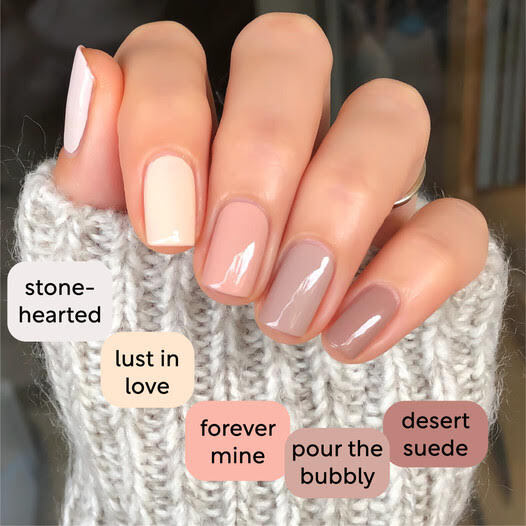 Neutral Skittle manicure with each nail a different nude shade, labeled with shade names