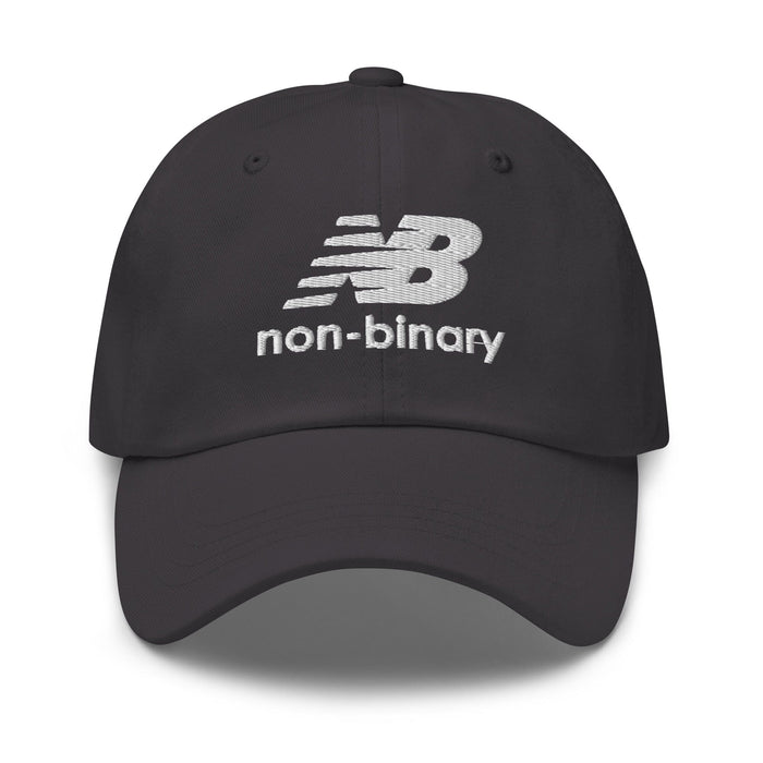 A dark gray baseball cap featuring a white embroidered 'non-binary' logo on the front, set against a plain white background.
