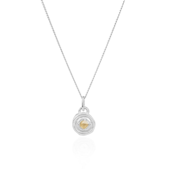 Necklace with a circular pendant featuring a heart design on a white background