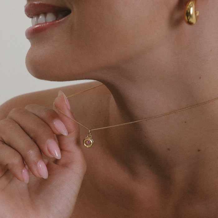 Elegant gold necklace featuring a luminous opal birthstone with captivating iridescent colors