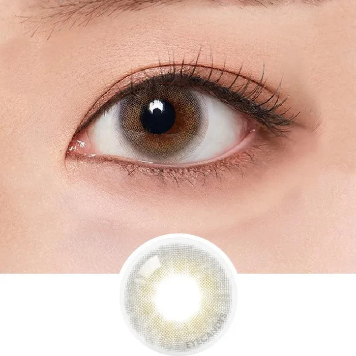 Macro shot of an eye wearing the Olola 1-Day Able Grey (10pk) (KR) colour contact lens, showing the multi-colored detail and natural effect on dark brown eyes, with clean eye makeup