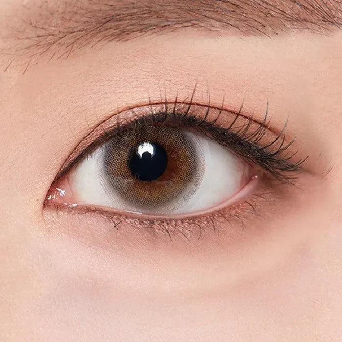 Macro shot of an eye wearing the Olola 1-Day Able Grey (10pk) (KR) prescription colour contact lens, showing the multi-colored detail and natural effect on dark brown eyes.