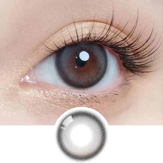 Macro shot of an eye wearing the Olola Blurring Grey colour contact lens, showing the multi-colored detail and natural effect on dark brown eyes, with clean eye makeup