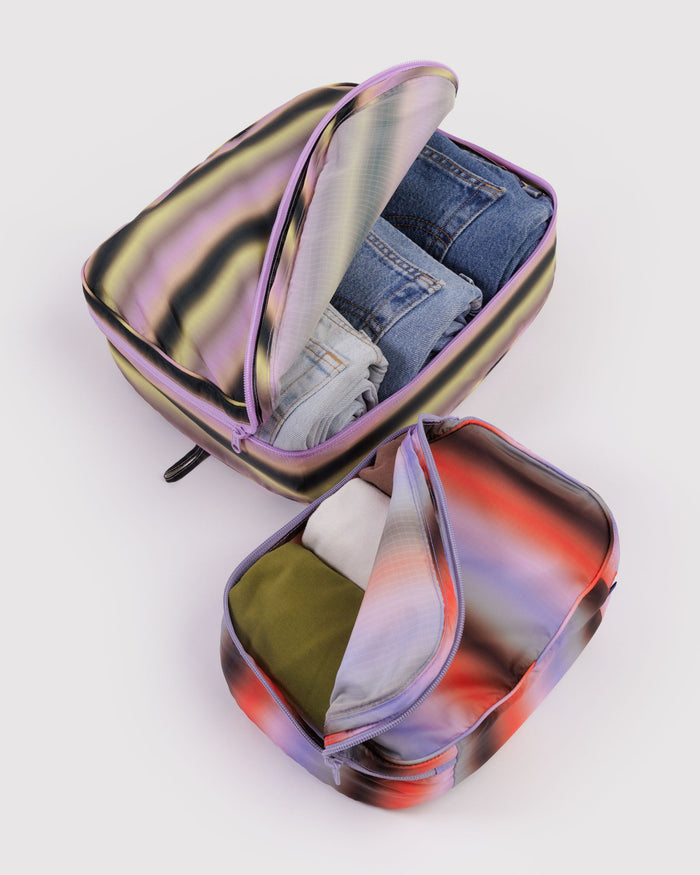 Packing cube set with iridescent gradient fabric, one cube open with lining