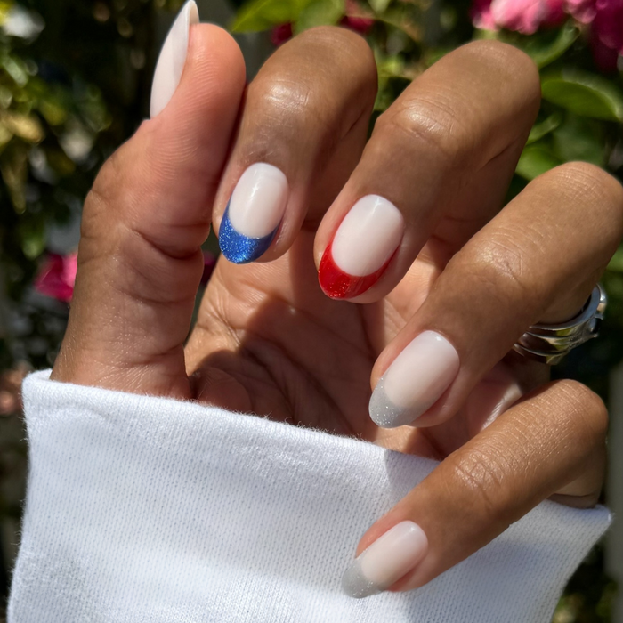 Parade Velvet French - Press-On | Medium | Oval with sheer milky base and glittery red, blue, and silver velvet tips manicure