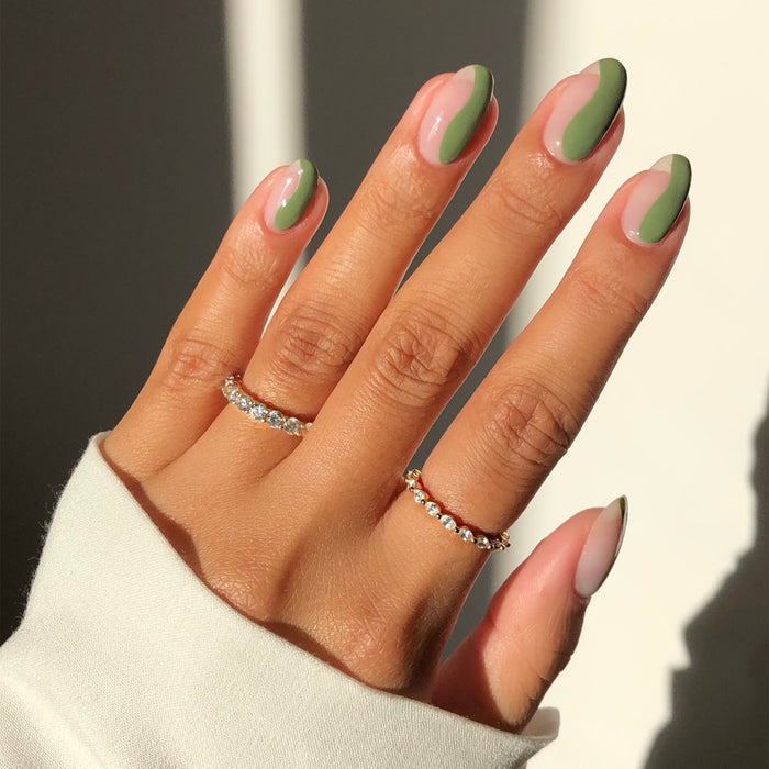 Paradise Isle green and peach French tip nail art on a medium skin tone in sunlight