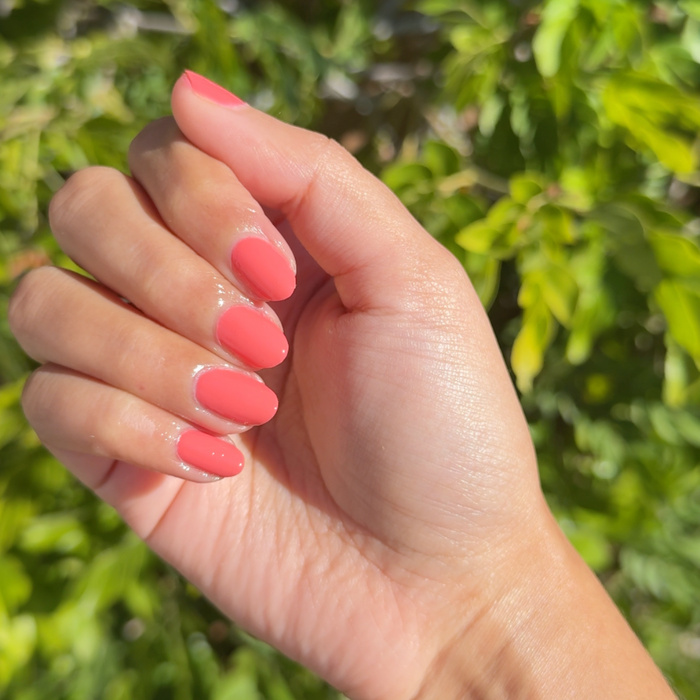 Perfect Pinwheel coral gel polish on natural nails with a smooth, shiny finish for a bright at-home manicure