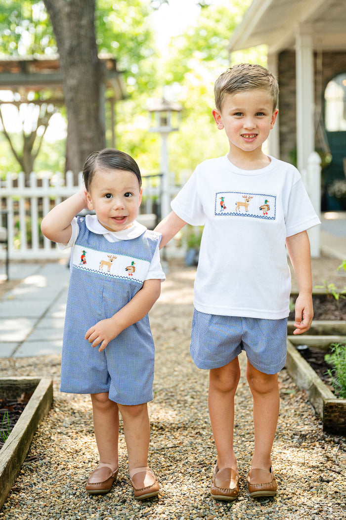 Two boys standing outdoors, one wearing Smocked Hunting Jon Jon by Ruth and Ralph, matching smocked hunting t-shirt