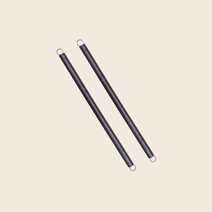 Pair of black Pilates springs for the Gratz Small Arm Chair, coiled with hooked ends.