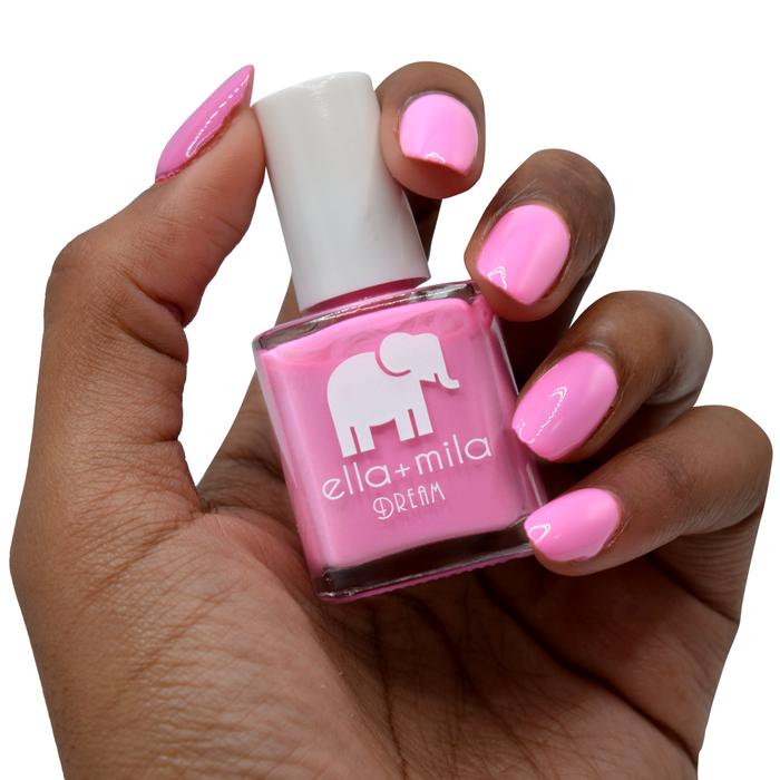 Pinkterest+ pink nail polish on a deep skin tone, hand holding the bottle
