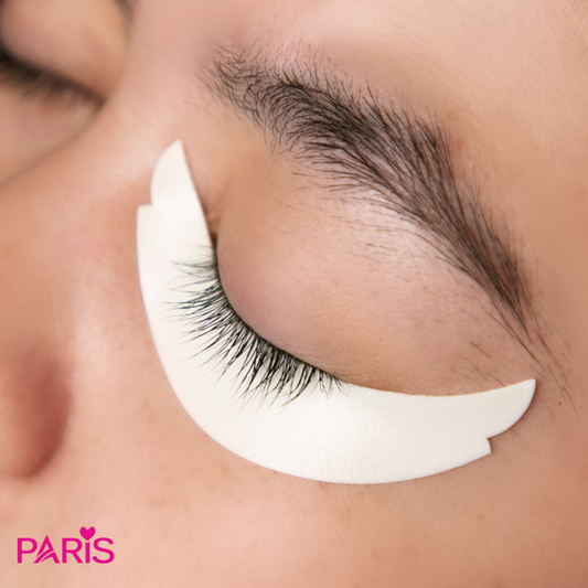 White foam eyepad on the bottom of a person's eye, brand 'PARIS' visible.