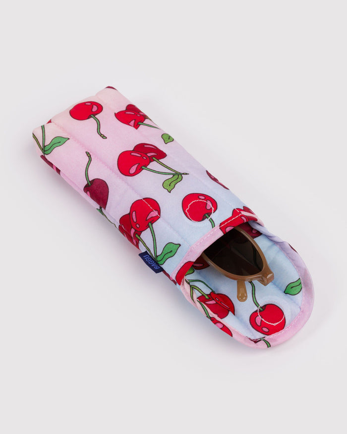 Padded glasses sleeve in pale pink with red cherry print and sunglasses inside