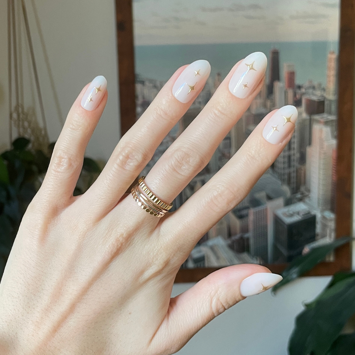 Puffy Sparkle - Press-On | Medium | Oval showing hand with medium oval nails in white and 3D gold sparkle design
