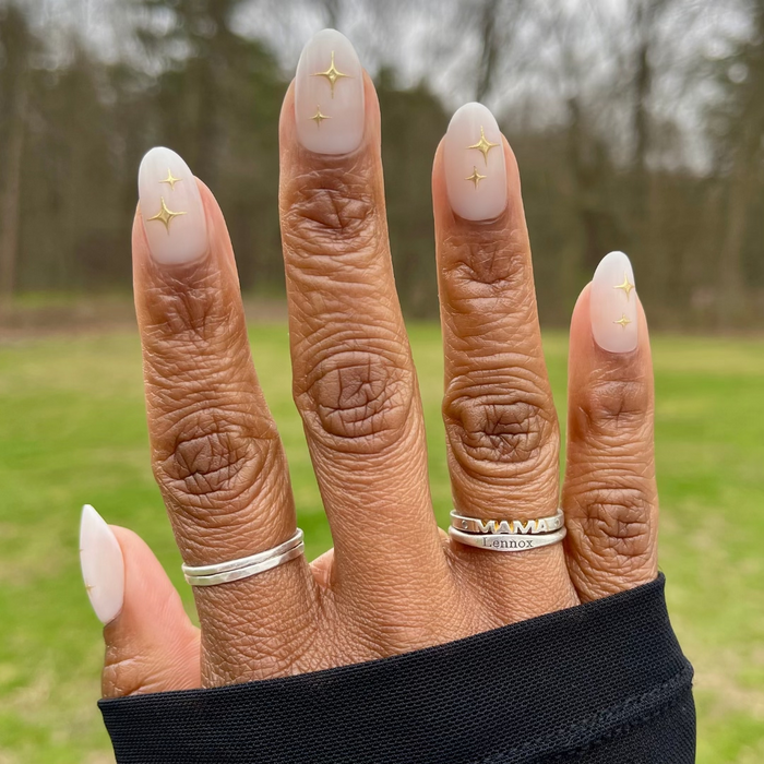 Puffy Sparkle - Press-On | Medium | Oval showing hand with medium oval press-on nails in soft neutral with 3D gold sparkle design