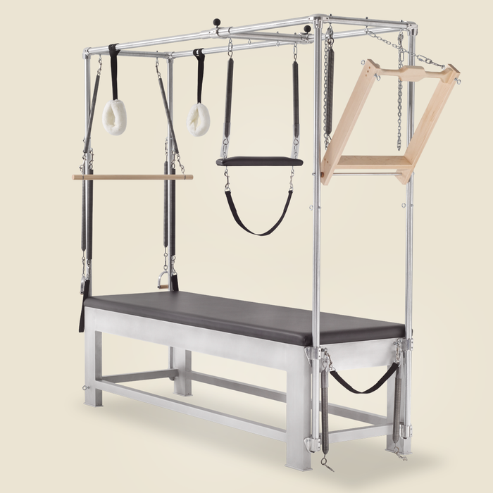Aluminum Gratz Cadillac Pilates apparatus fitted with push through bar springs, straps, and trapeze.