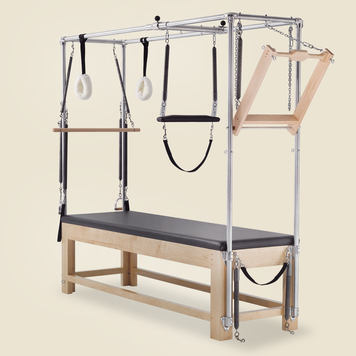 Gratz Pilates Cadillac apparatus with push-through bar, springs, straps, and fuzzy loops.