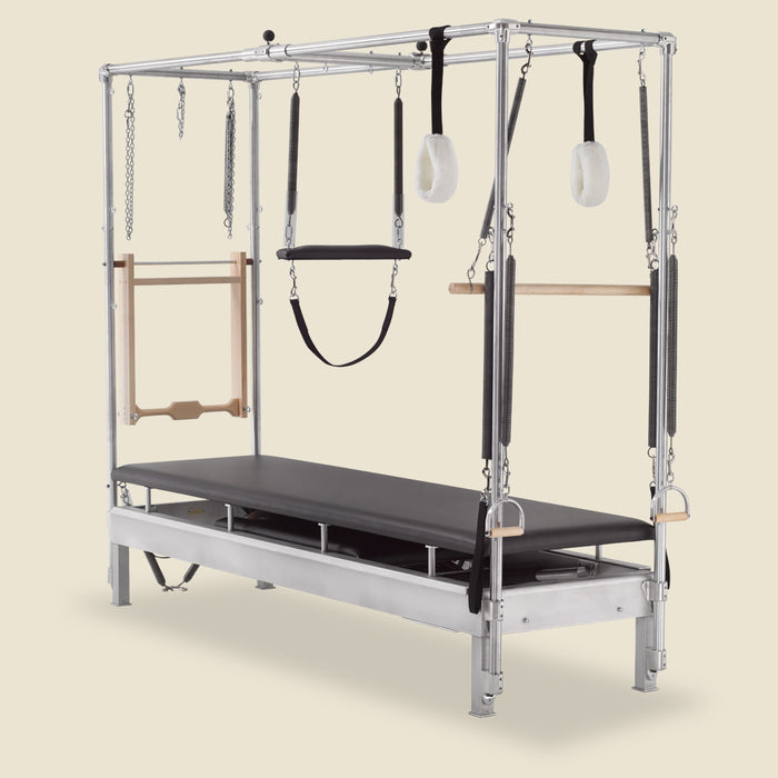 Gratz Pilates Cadillac apparatus with push-thru bar, springs, and fuzzy loop straps attached.
