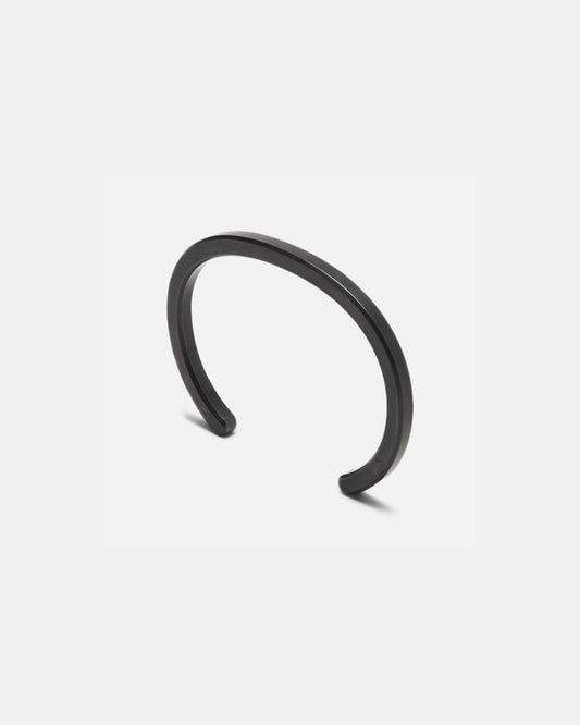 Radial cuff bracelet in dark black metal, curved open band