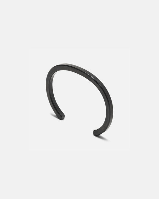 Radial cuff bracelet with dark black curved open bangle and smooth finish