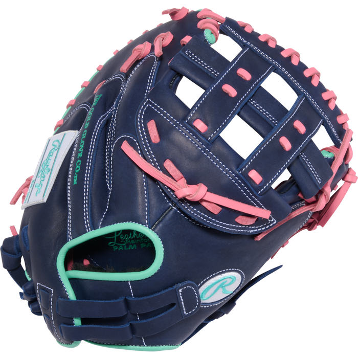 The Rawlings R9 33" Fastpitch Catcher's Mitt (R9SBCM33-24NMP) features navy blue leather, pink laces, teal accents, white stitching, and Rawlings logos on the palm and wrist strap—a standout softball glove.