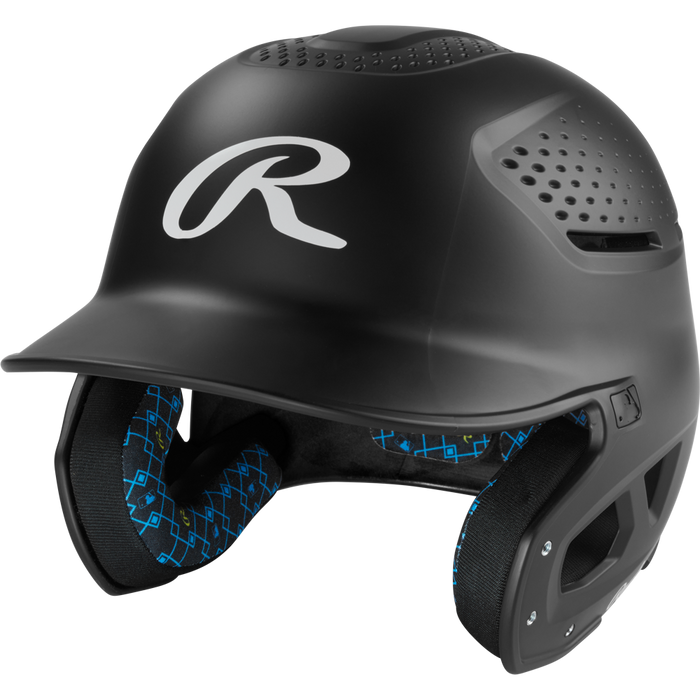The Rawlings RX2 Matte Batting Helmet: RX2MAT is a matte black youth helmet with ventilation holes, a protective face guard, blue-patterned interior padding, and a large white R logo on the front.