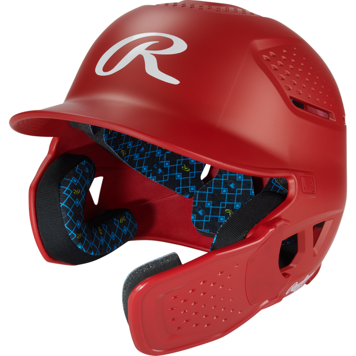The Rawlings RX2 Reverse Matte Batting Helmet: RX2REVMAT in scarlet features a reversible flap system, protective face guard, blue patterned interior padding, ventilation holes, and offers NOCSAE-certified protection for every player.