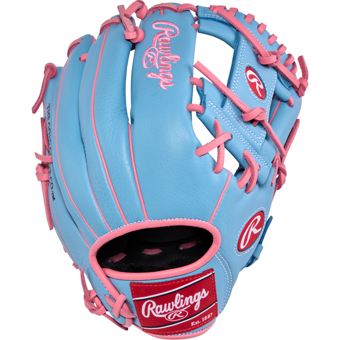 A light blue Rawlings Select Pro Lite 11.5″ Manny Machado Baseball Glove (SPL150MMCB) featuring pink laces and accents. The glove displays the Rawlings logo in pink and white, inspired by the Manny Machado series, with a red wrist patch bearing white text.
