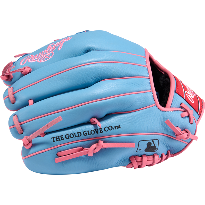 A light blue Rawlings Select Pro Lite 11.5″ Manny Machado Baseball Glove (SPL150MMCB) for youth infielders, accented with pink laces and trim, and displaying the Rawlings logo alongside THE GOLD GLOVE CO. text on the side—crafted in the style inspired by Manny Machado.