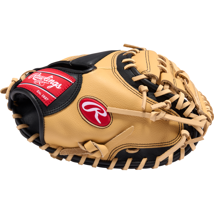 A tan and black Rawlings Select Pro Lite 32″ Cal Raleigh Baseball Catcher’s Mitt (model SPLCM32CR) with prominent red and white Rawlings logos, detailed leather stitching, and laces. This youth catcher’s mitt is shown palm down, displaying its outer side.
