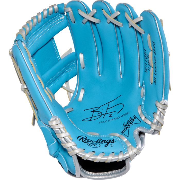 A Rawlings Sure Catch 11″ Brice Turang youth baseball glove in turquoise with white laces, black printed text, and a signature on the palm.